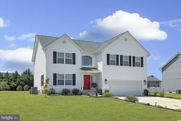 a front view of house with yard and green space