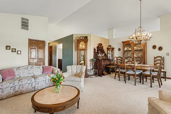 a living room with furniture and a chandelier