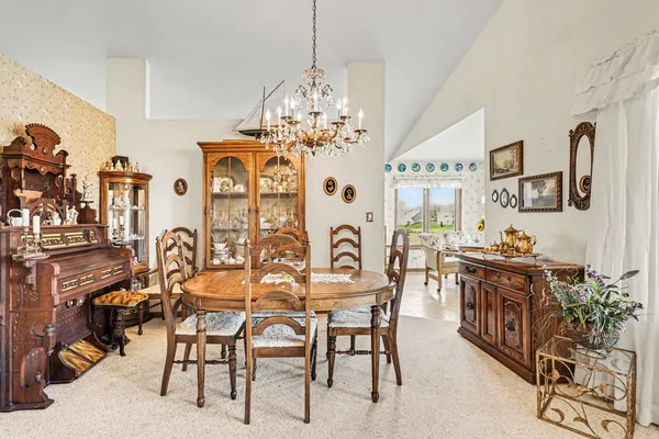 a view of a dining room with furniture and chandelier