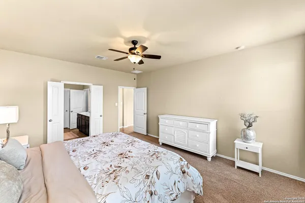 a bedroom with a bed dresser and a window