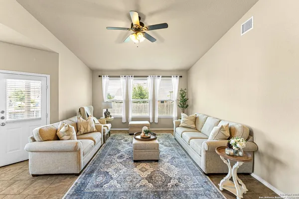 a living room with furniture and a large window