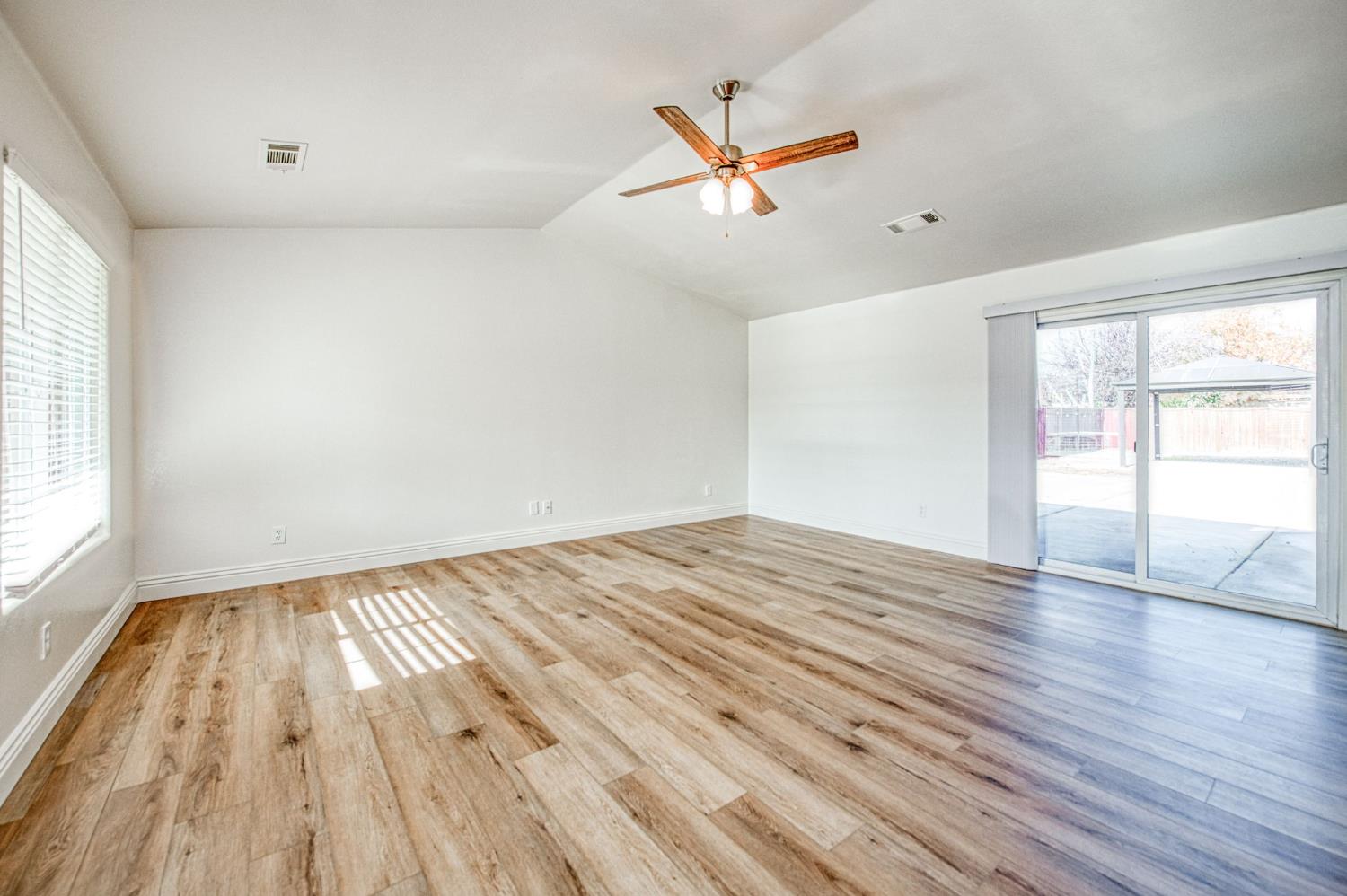 5176 West Michigan Avenue Fresno, CA 93722 - Photo 22 of 37 wooden floor in an empty room with a window