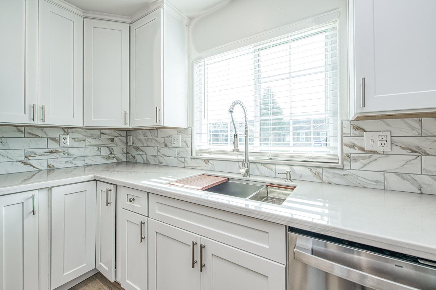 5176 West Michigan Avenue Fresno, CA 93722 - Photo 30 of 37 a kitchen with a sink and a window