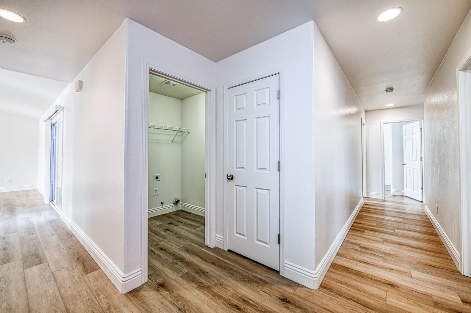 5176 West Michigan Avenue Fresno, CA 93722 - Photo 32 of 37 a view of a hallway with wooden floor and staircase