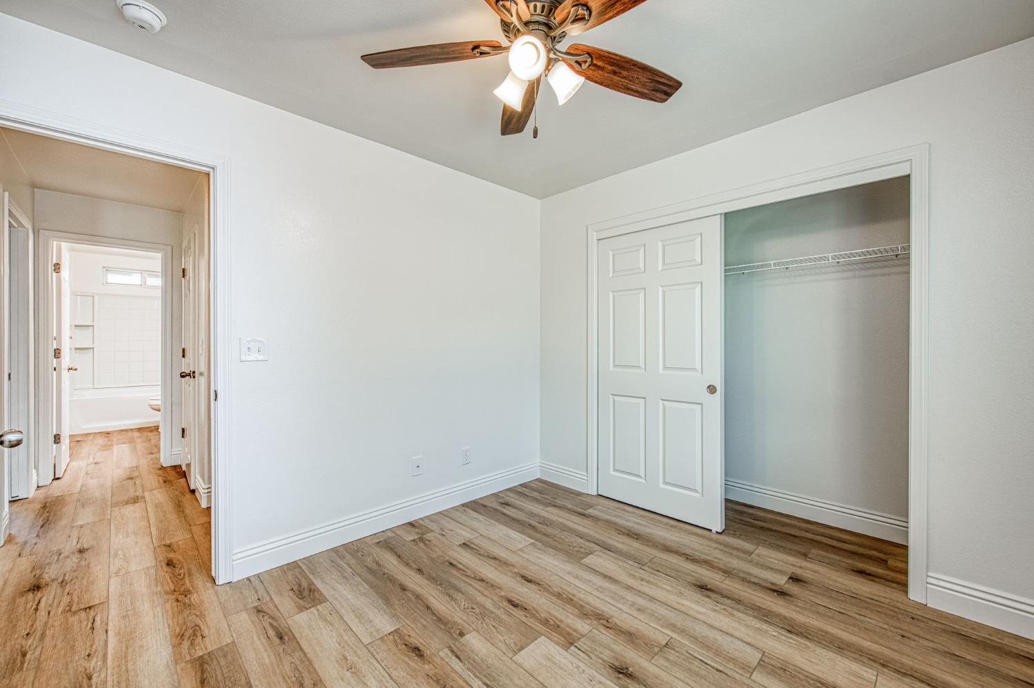 5176 West Michigan Avenue Fresno, CA 93722 - Photo 35 of 37 a view of empty room with wooden floor