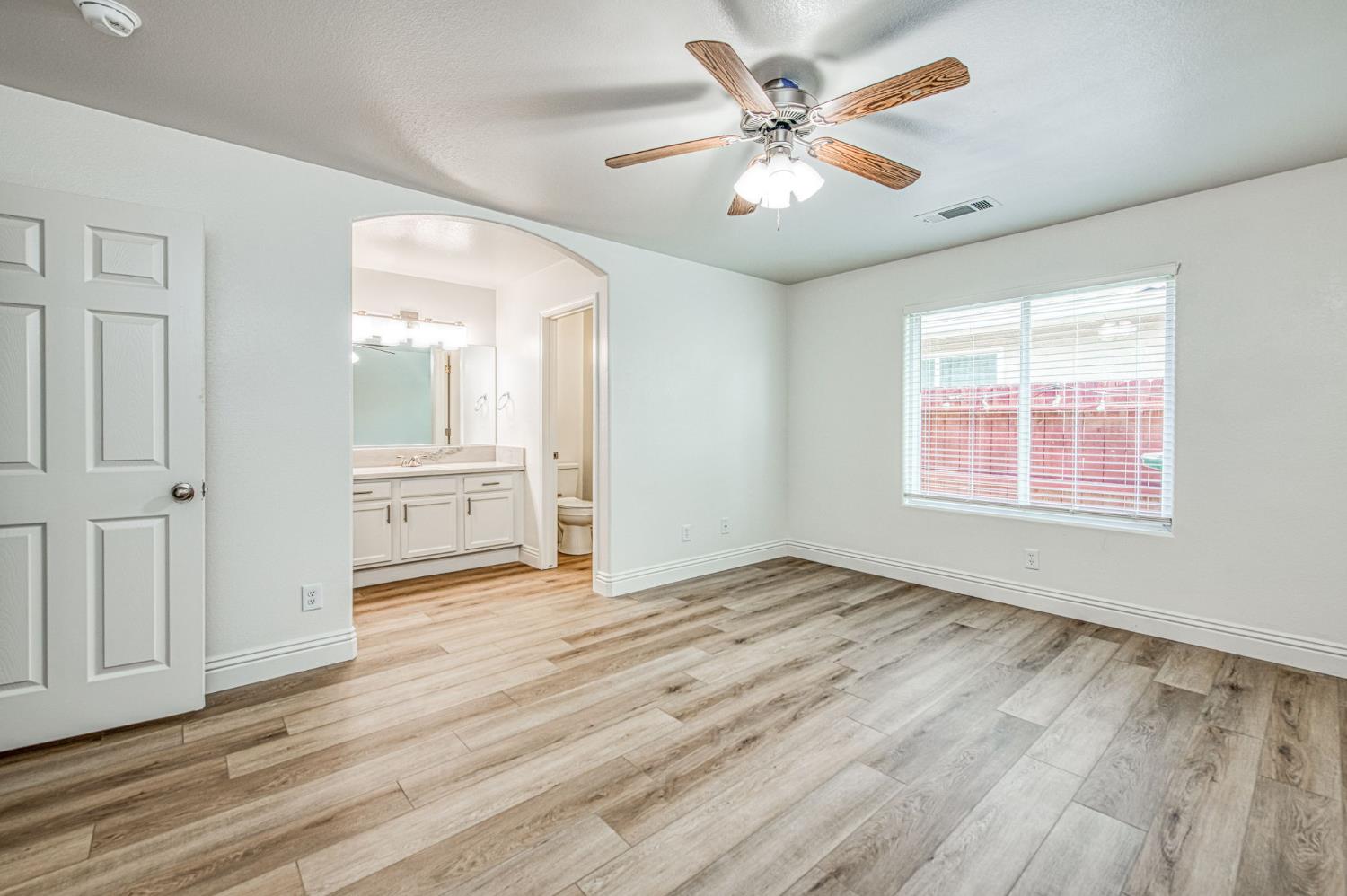 5176 West Michigan Avenue Fresno, CA 93722 - Photo 10 of 37 wooden floor in an empty room with a window