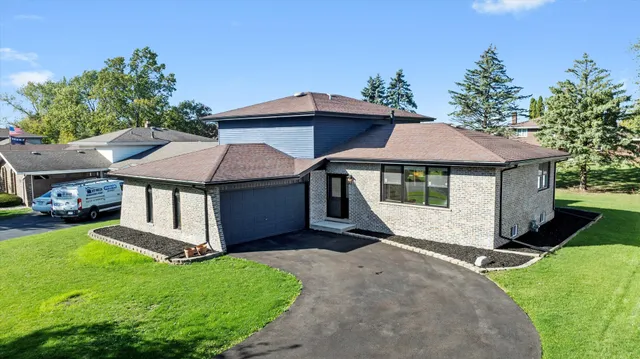 a white house covered with tall trees