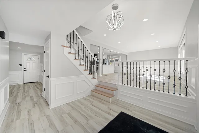 a view of entryway and hall with wooden floor