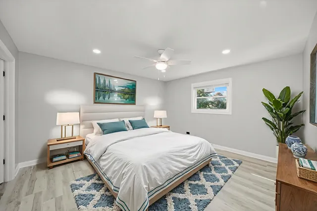 a bedroom with bed and a potted plant
