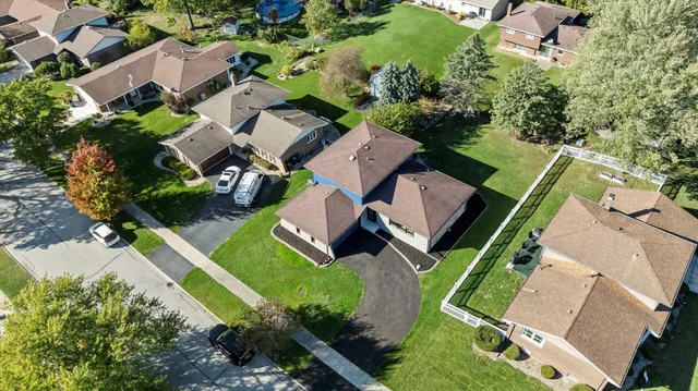 an aerial view of a house with a garden and swimming pool