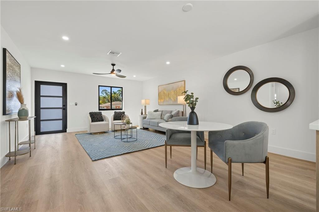 3613 Poplar Way Naples, FL 34112 - Photo 14 of 43 a living room with furniture a rug and a wall painting