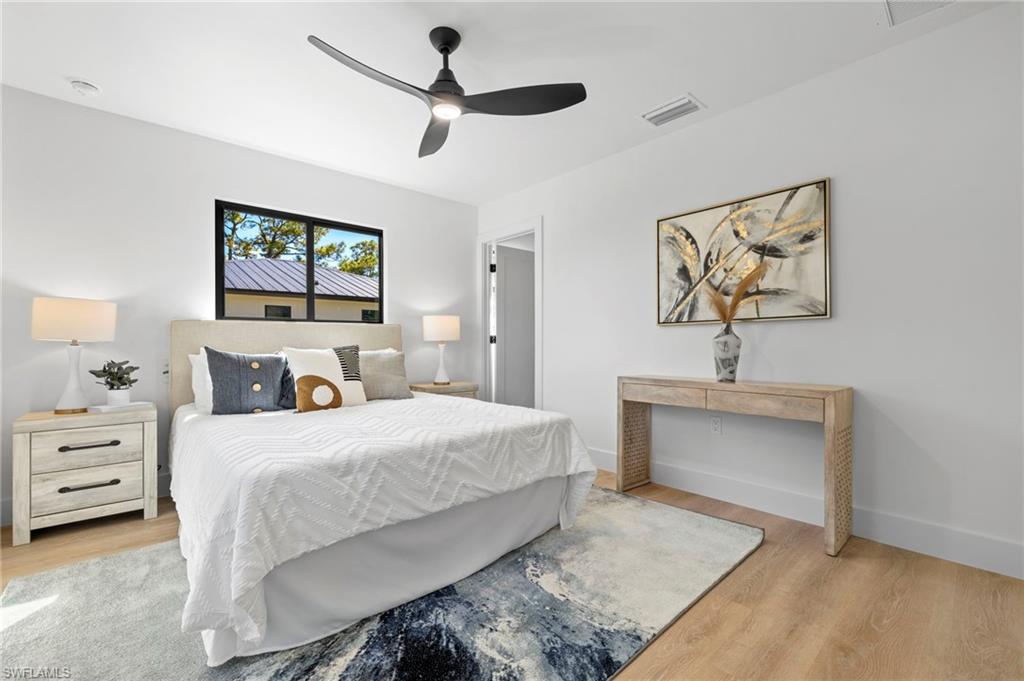 3613 Poplar Way Naples, FL 34112 - Photo 17 of 43 a bedroom with bed and a chandelier