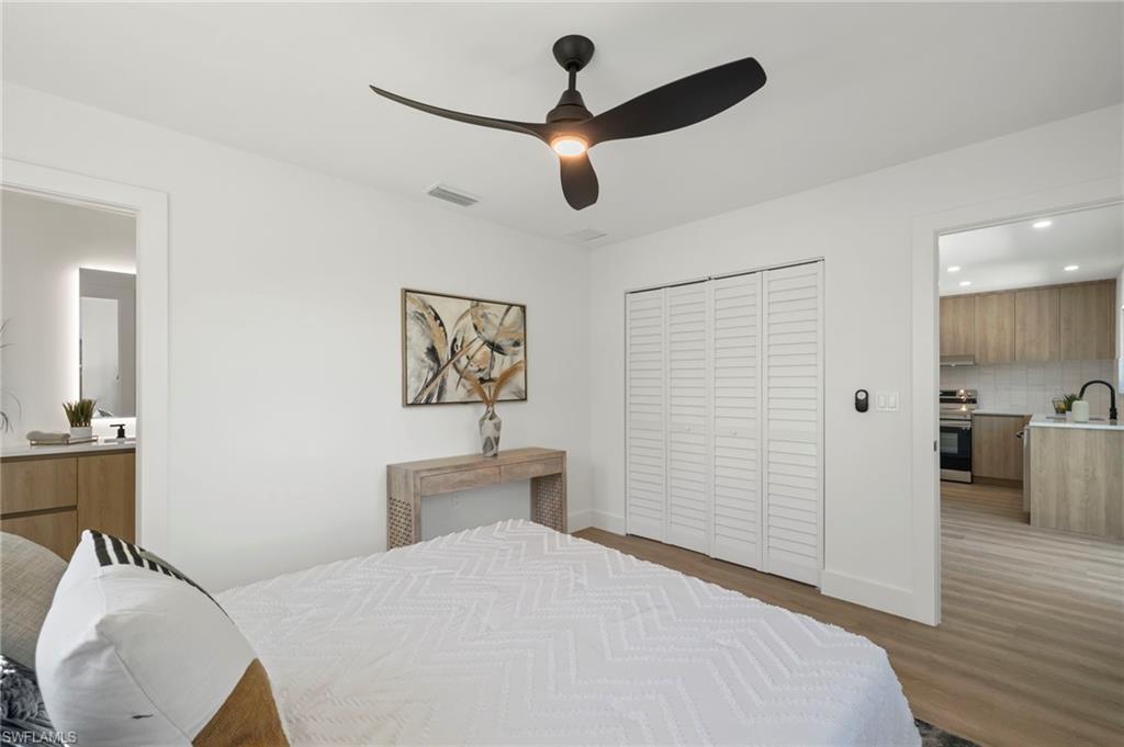 3613 Poplar Way Naples, FL 34112 - Photo 19 of 43 a bedroom with a bed and a chandelier