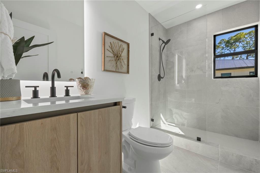 3613 Poplar Way Naples, FL 34112 - Photo 22 of 43 a bathroom with a sink a toilet and shower