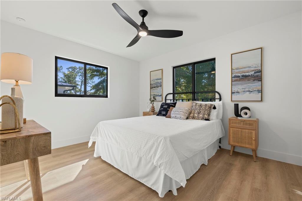 3613 Poplar Way Naples, FL 34112 - Photo 23 of 43 a bed room with a bed and a tv