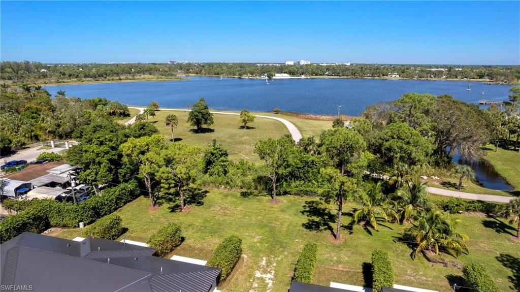 3613 Poplar Way Naples, FL 34112 - Photo 38 of 43 a view of a lake with houses in the back