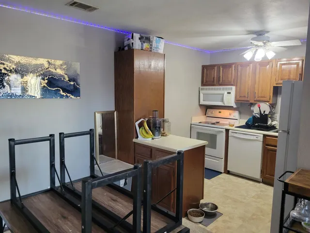 a view of kitchen with cabinets and wooden floor