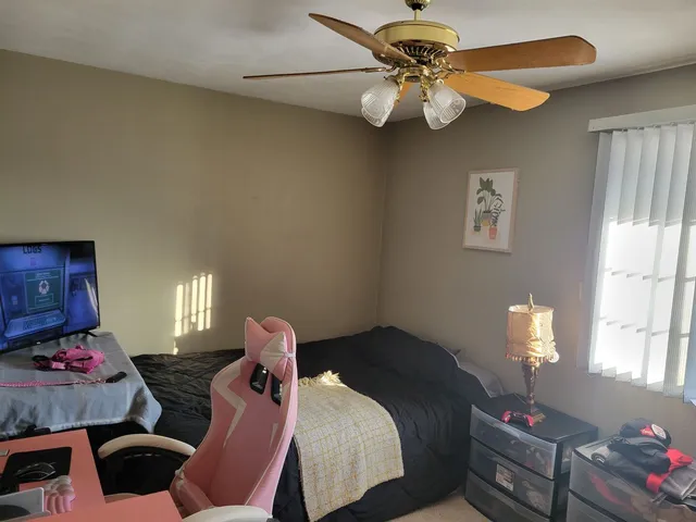 a bedroom with bed and a chandelier