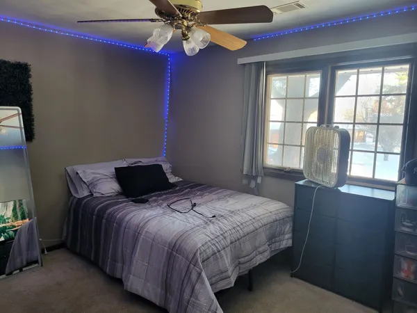 a bedroom with a bed and glass window