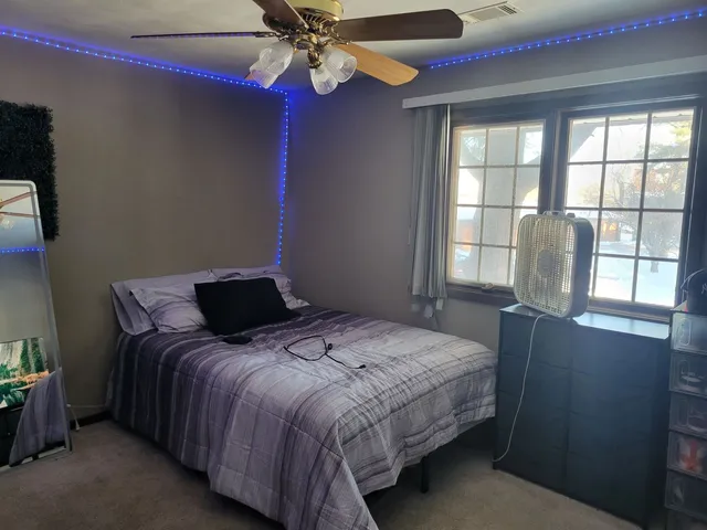 a bedroom with a bed and glass window