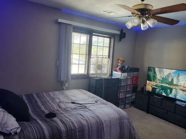 a bedroom with a bed and a flat screen tv