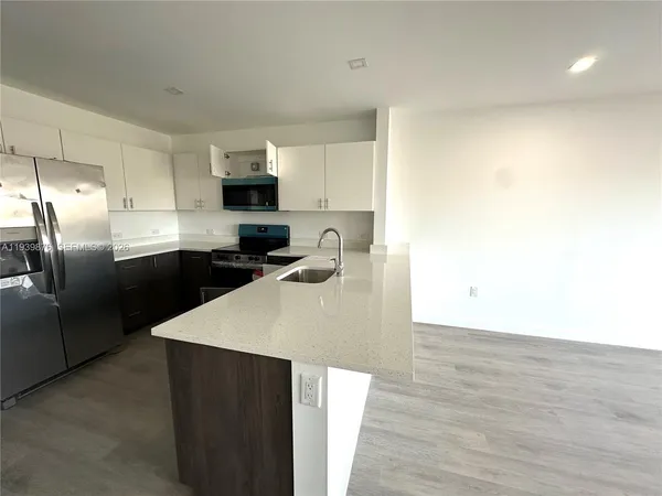 a bathroom with a granite countertop sink mirror toilet and bathtub