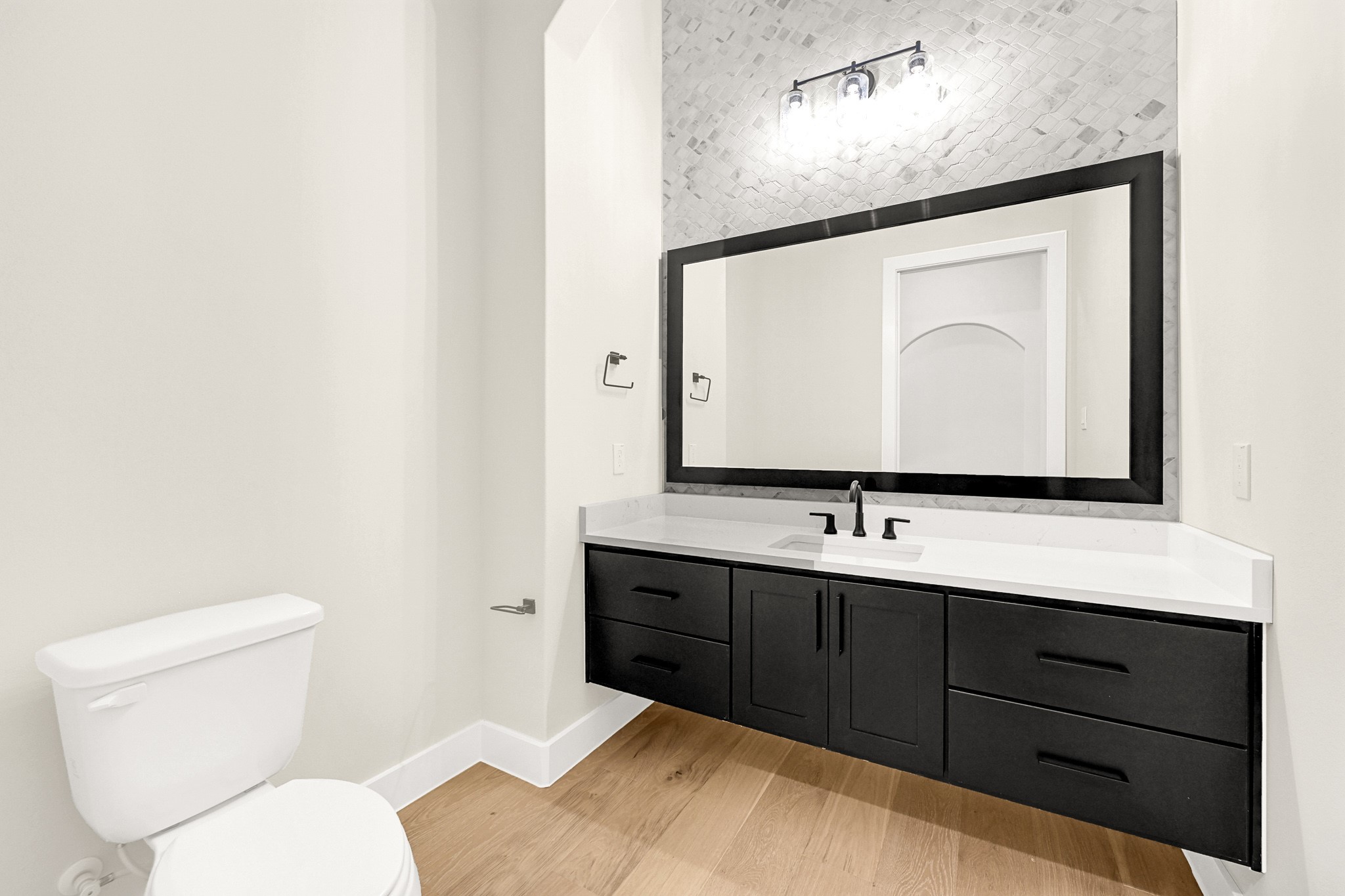 21230 Adriatic Run Drive Cypress, TX 77433 - Photo 23 of 50 a bathroom with a toilet sink and mirror