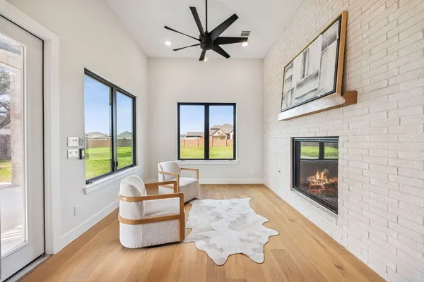 an empty room with windows and fan