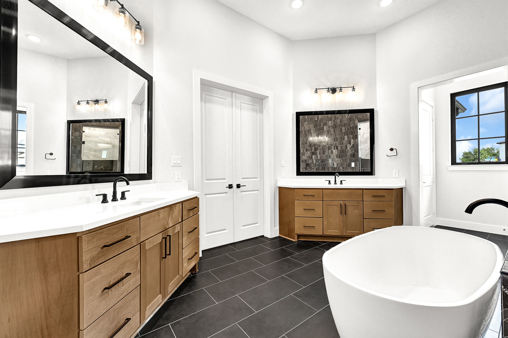 21230 Adriatic Run Drive Cypress, TX 77433 - Photo 34 of 50 a bathroom with a double vanity sink mirror and bathtub
