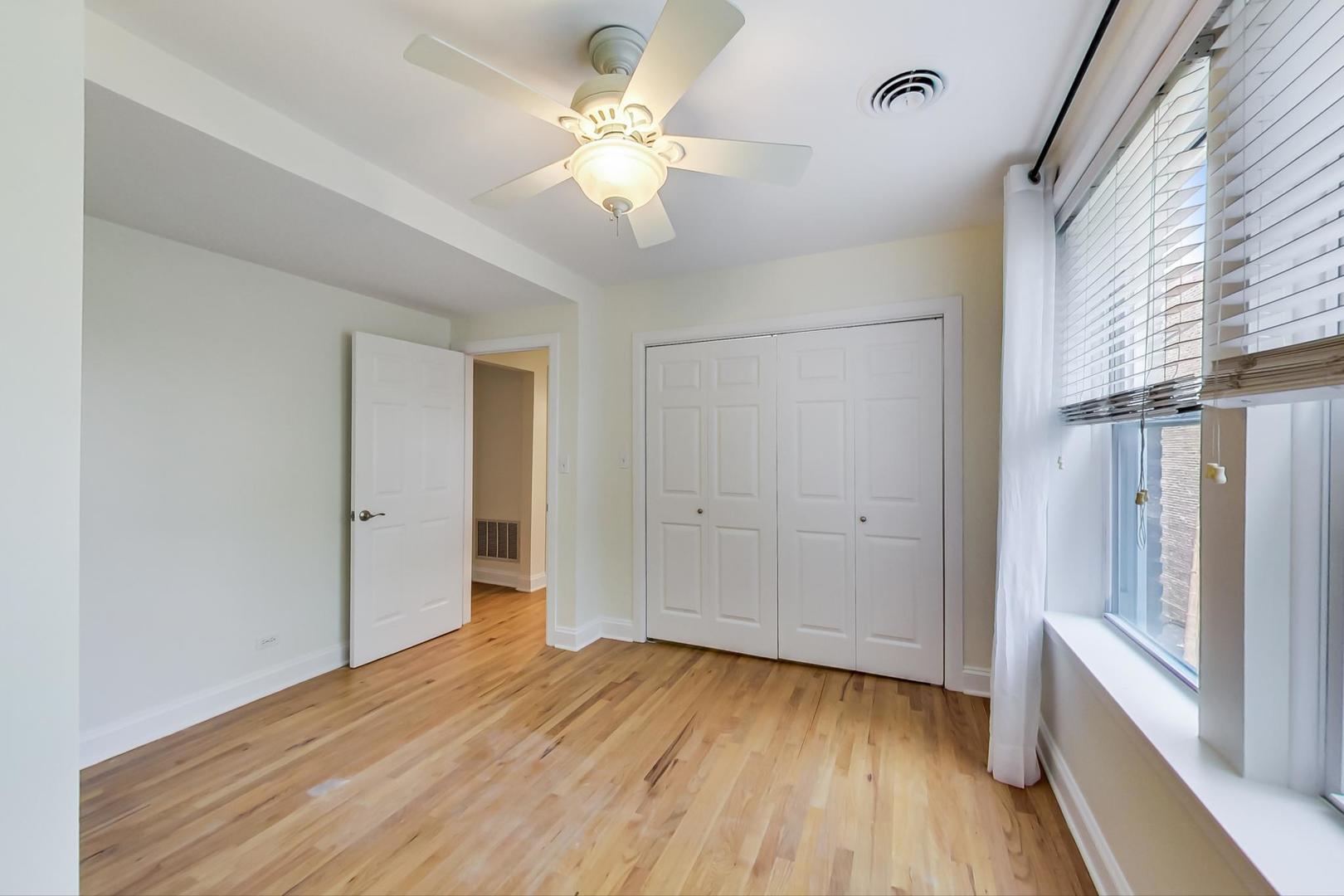 4109 North Sheridan Road, Unit 2S Chicago, IL 60613 - Photo 11 of 17 a view of an empty room with wooden floor and a window