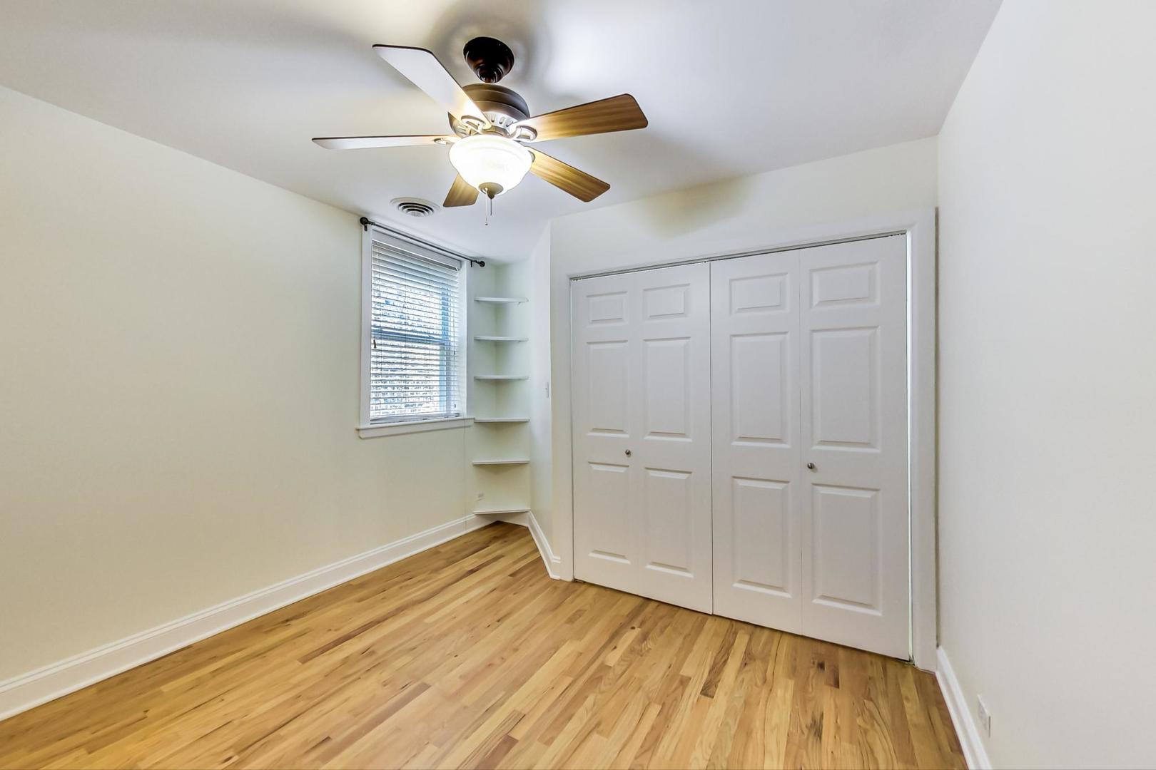 4109 North Sheridan Road, Unit 2S Chicago, IL 60613 - Photo 13 of 17 a view of an empty room with wooden floor and a window