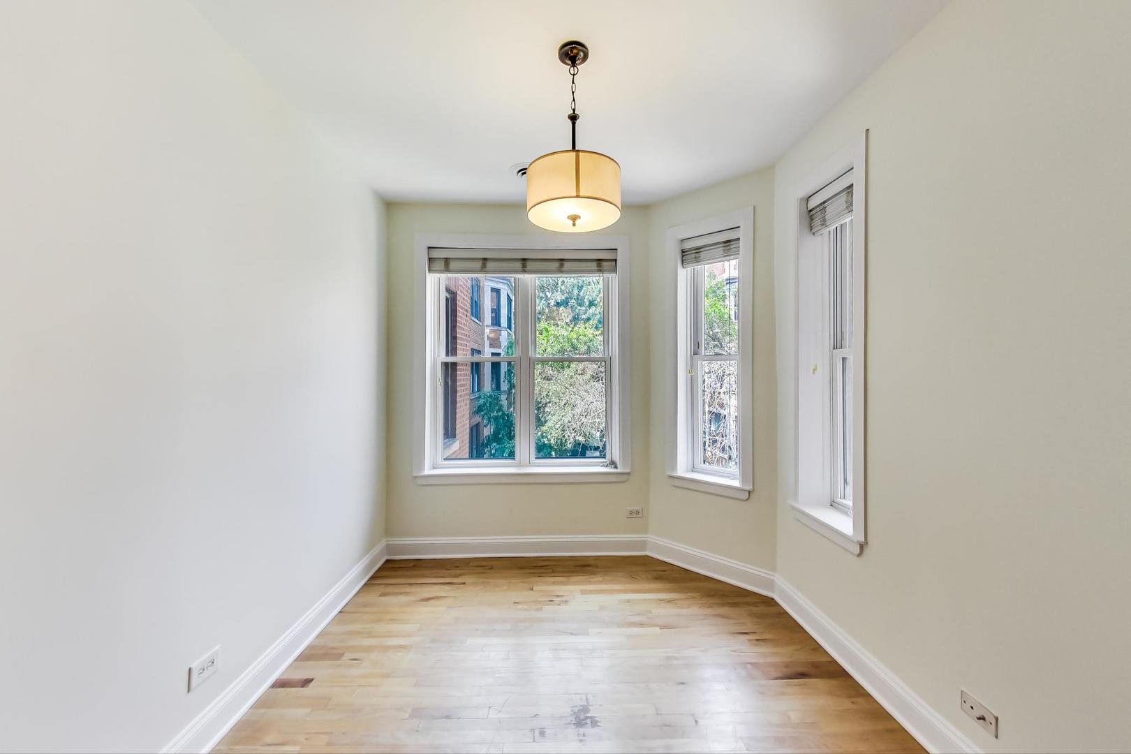 4109 North Sheridan Road, Unit 2S Chicago, IL 60613 - Photo 5 of 17 an empty room with wooden floor windows and entrance
