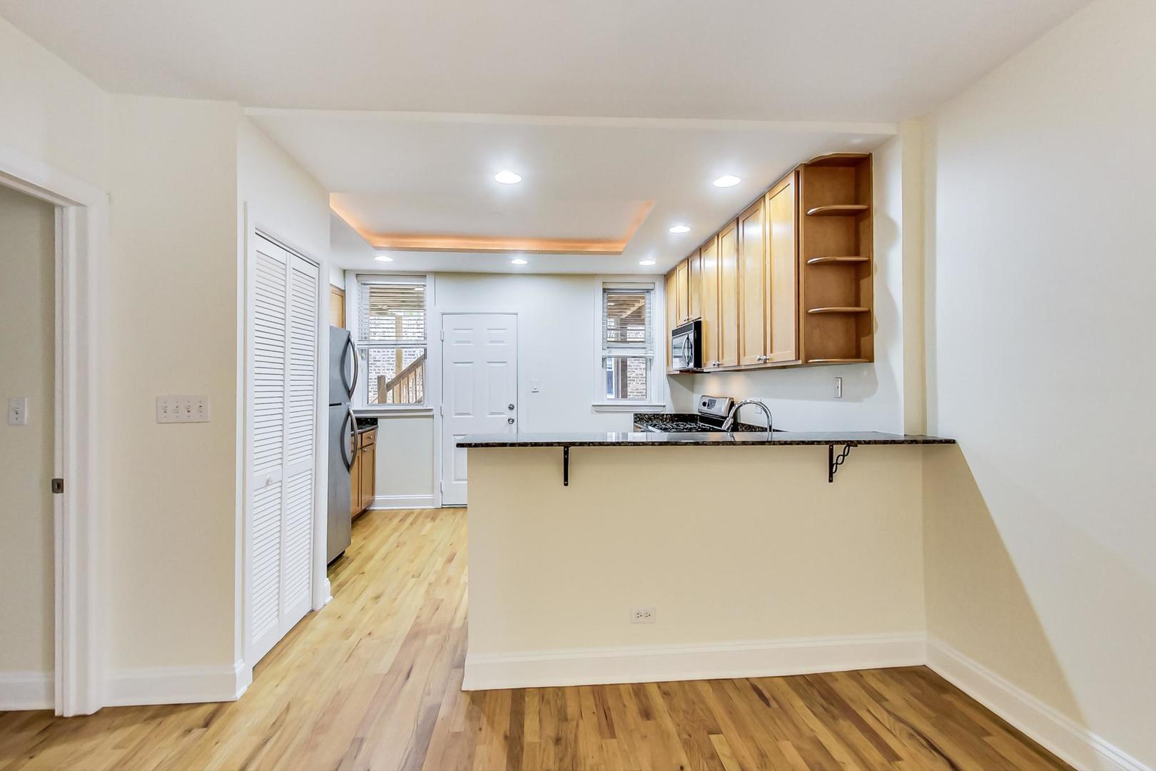 4109 North Sheridan Road, Unit 2S Chicago, IL 60613 - Photo 6 of 17 a view of kitchen and wooden floor
