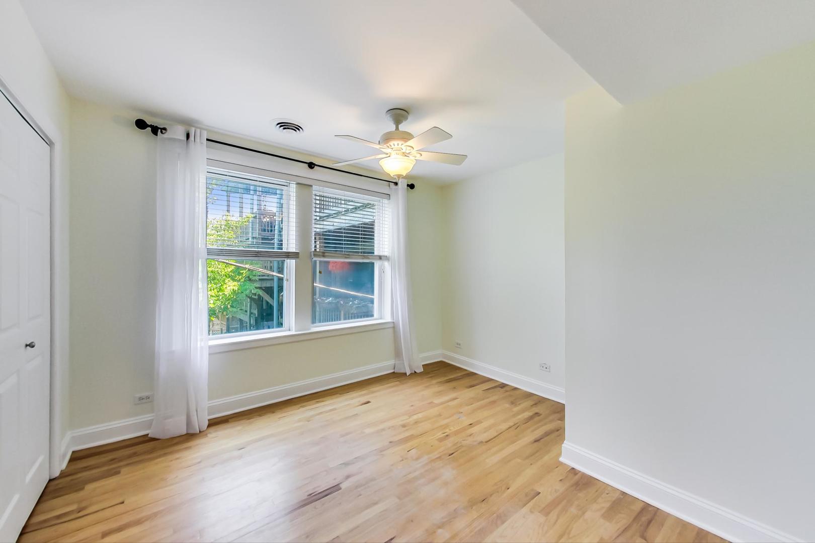 4109 North Sheridan Road, Unit 2S Chicago, IL 60613 - Photo 10 of 17 wooden floor in an empty room with a window