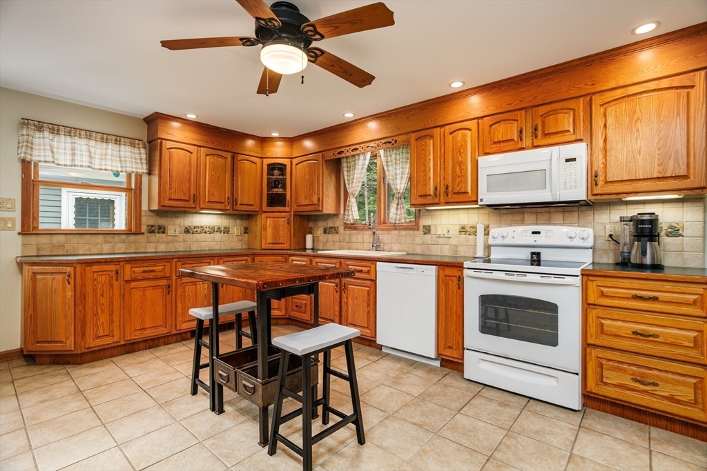 25 Ellis Road Westminster, MA 01473 - Photo 6 of 32 a kitchen with stainless steel appliances granite countertop a stove a sink dishwasher and a refrigerator with wooden cabinets