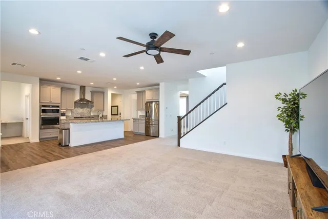 wooden floor with windows and ceiling fan