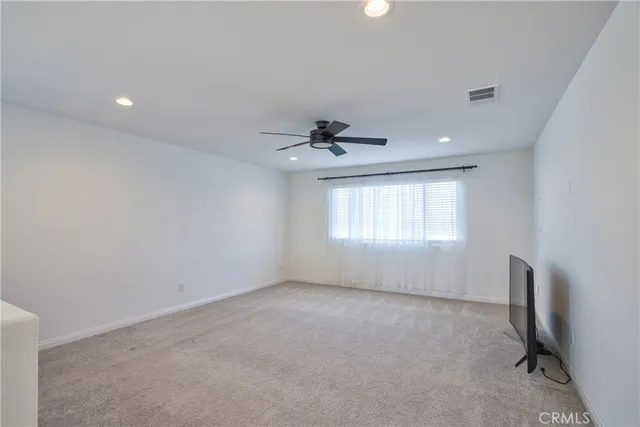 a bed room with a bed and a ceiling fan