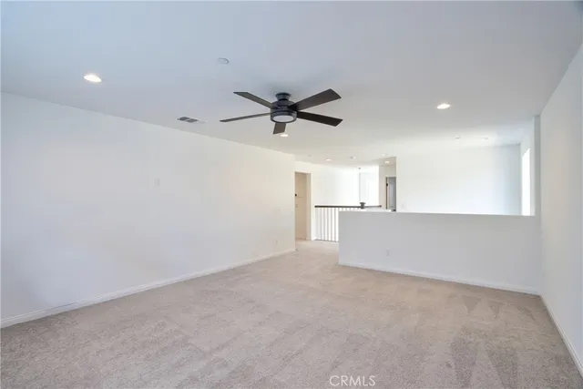 a bedroom with a bed and a ceiling fan