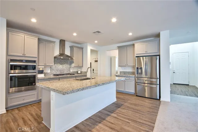 a kitchen with sink stove and cabinets