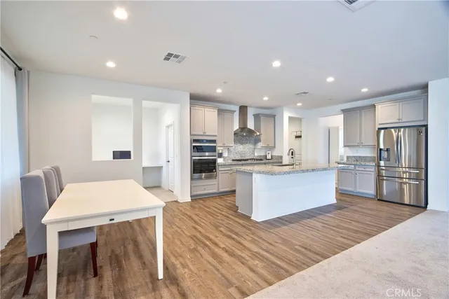 a kitchen with stainless steel appliances granite countertop a stove and a sink