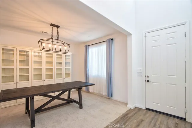 a view of an empty room with stairs wooden floor and a ceiling fan