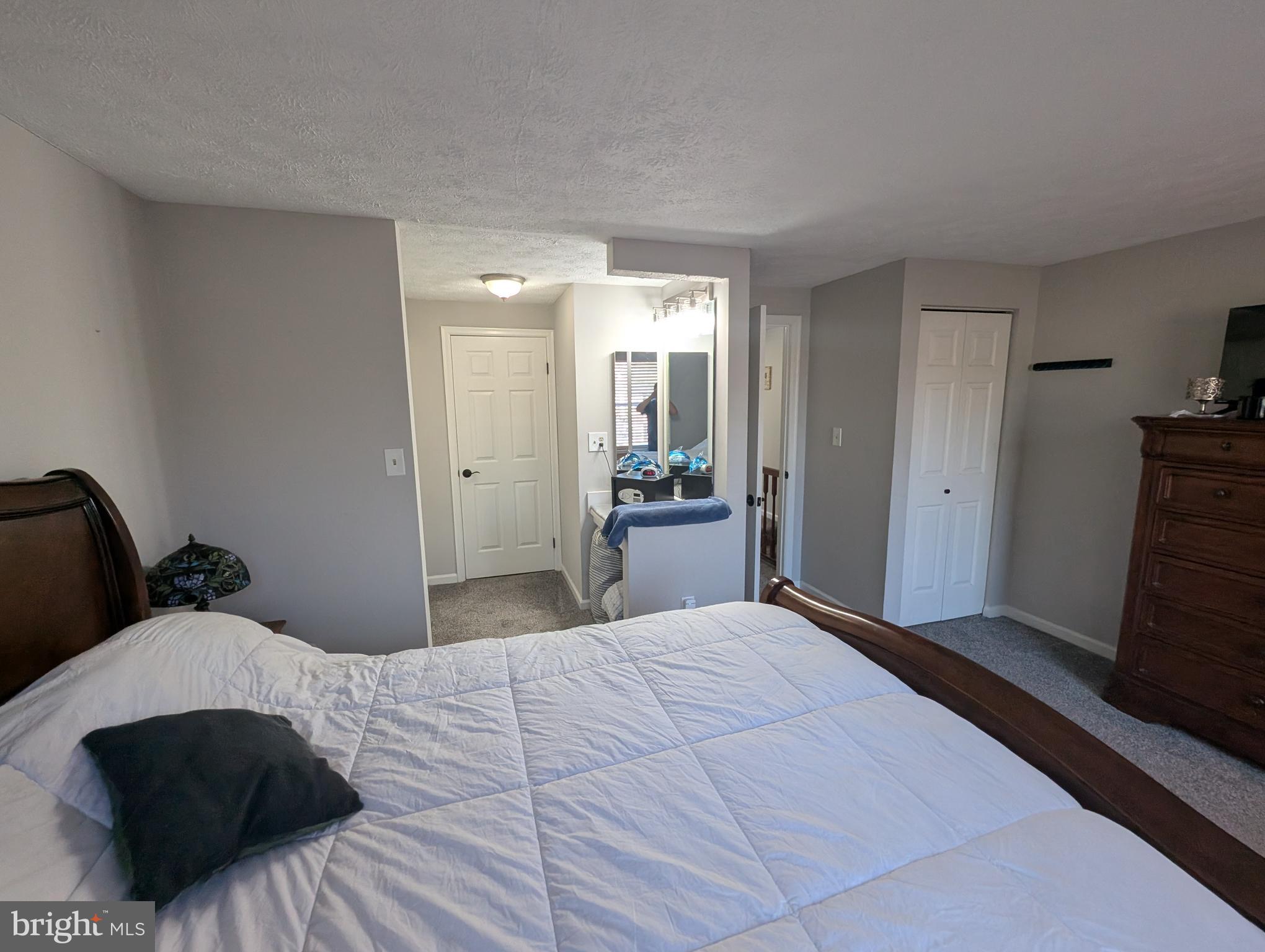 3639 Handel Court, Unit 75 Pasadena, MD 21122 - Photo 16 of 24 a bedroom with a large bed and wooden floor