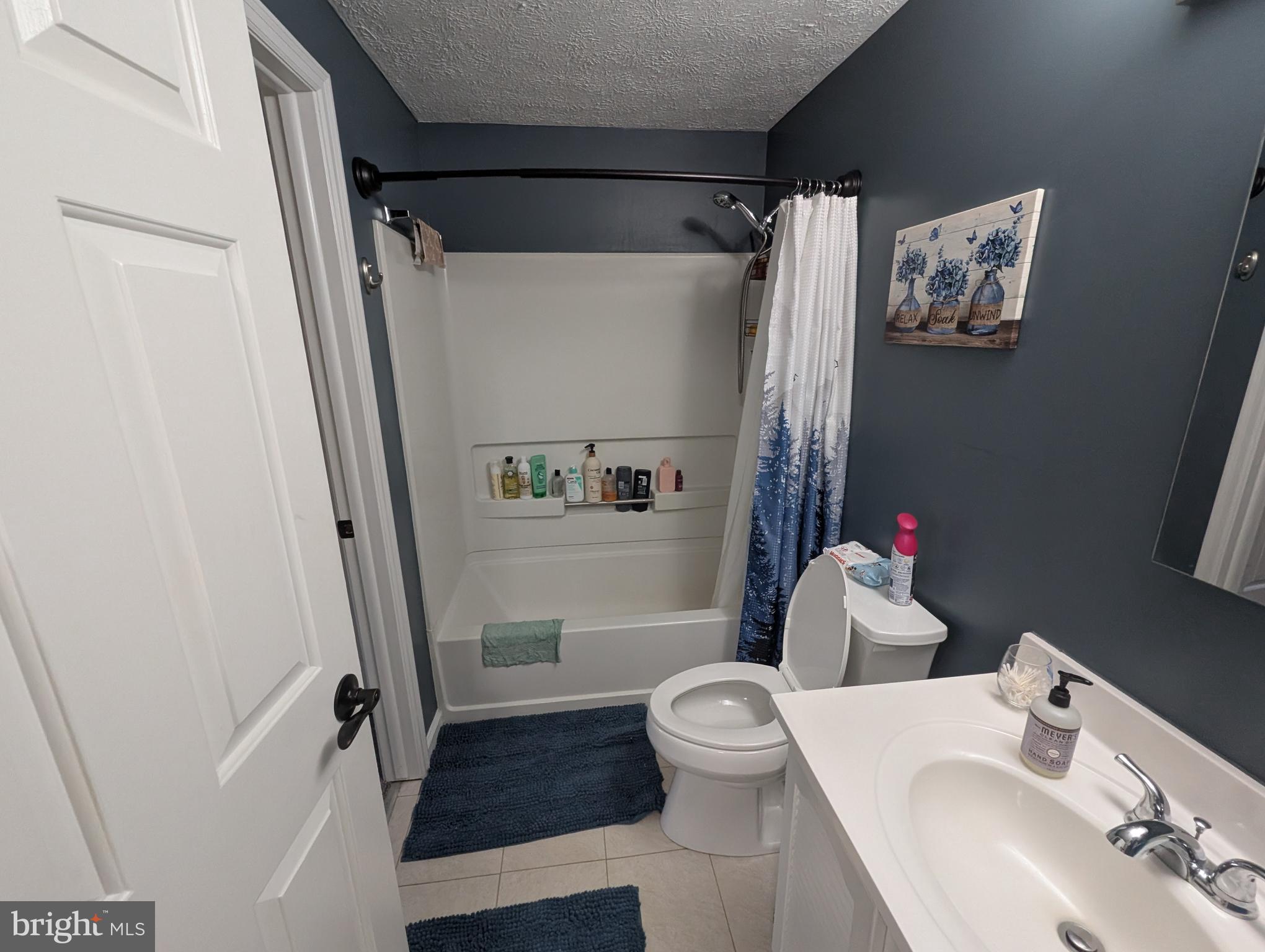 3639 Handel Court, Unit 75 Pasadena, MD 21122 - Photo 19 of 24 a white toilet sitting next to a bathroom sink and tub