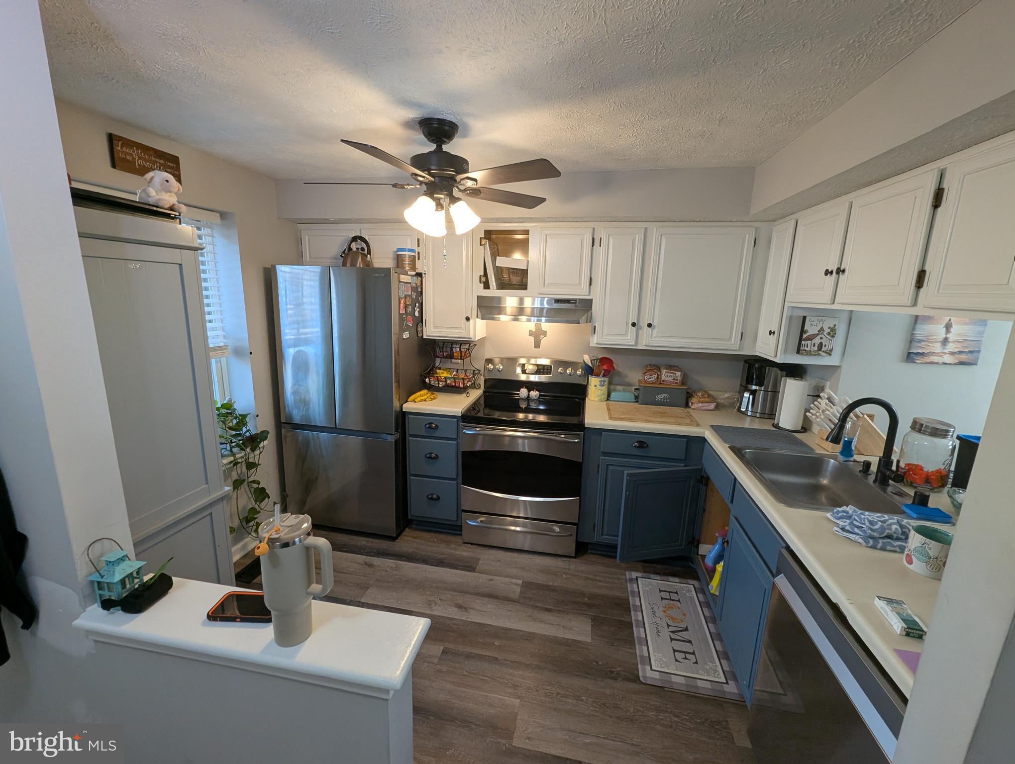 3639 Handel Court, Unit 75 Pasadena, MD 21122 - Photo 6 of 24 a kitchen with stainless steel appliances granite countertop a refrigerator stove and sink