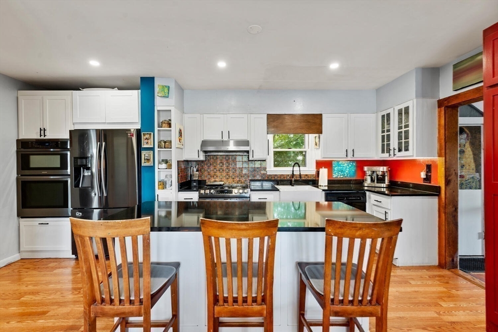 28 Gordon Road Medford, MA 02155 - Photo 2 of 41 a kitchen with stainless steel appliances a dining table chairs refrigerator and a view of living room