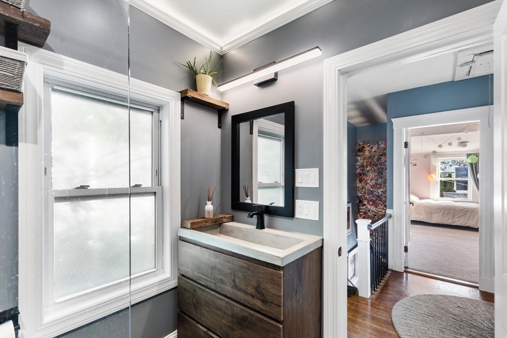28 Gordon Road Medford, MA 02155 - Photo 29 of 41 a bathroom with a sink a mirror and a shower