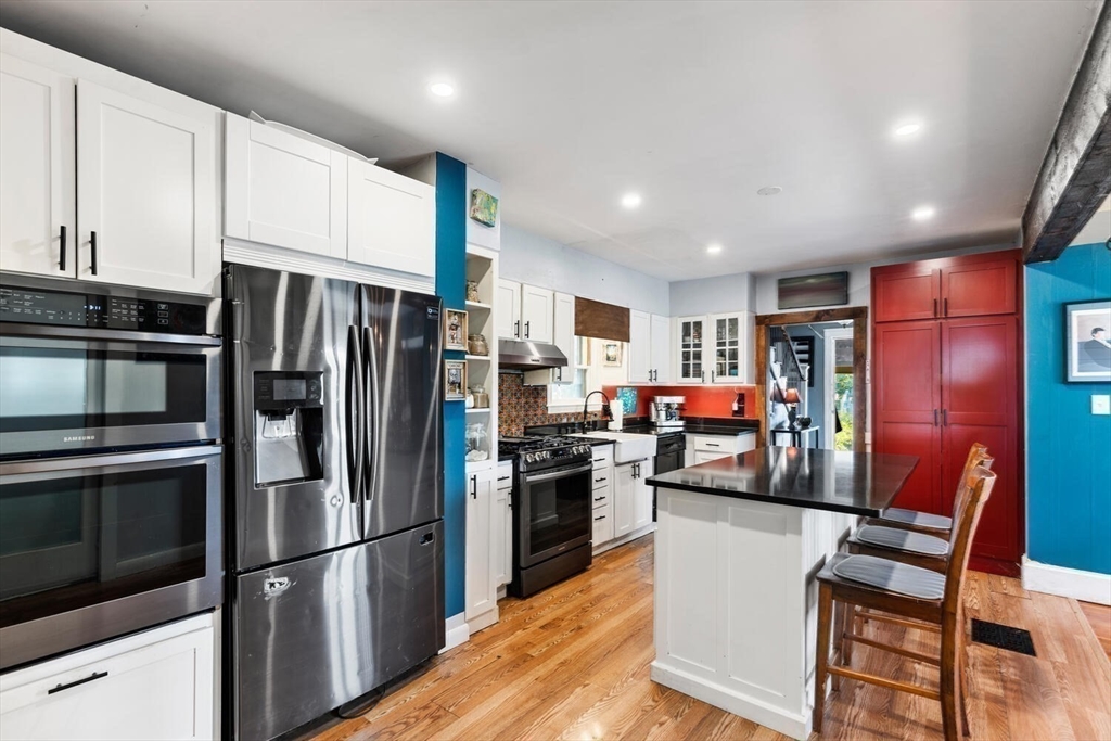 28 Gordon Road Medford, MA 02155 - Photo 4 of 41 a kitchen with stainless steel appliances and refrigerator