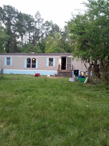 a front view of house with yard and green space