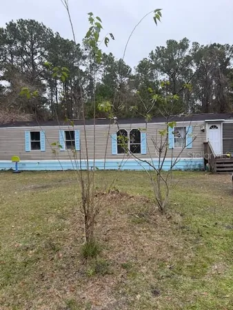 a backyard of a house with table and chairs