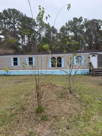 a backyard of a house with table and chairs